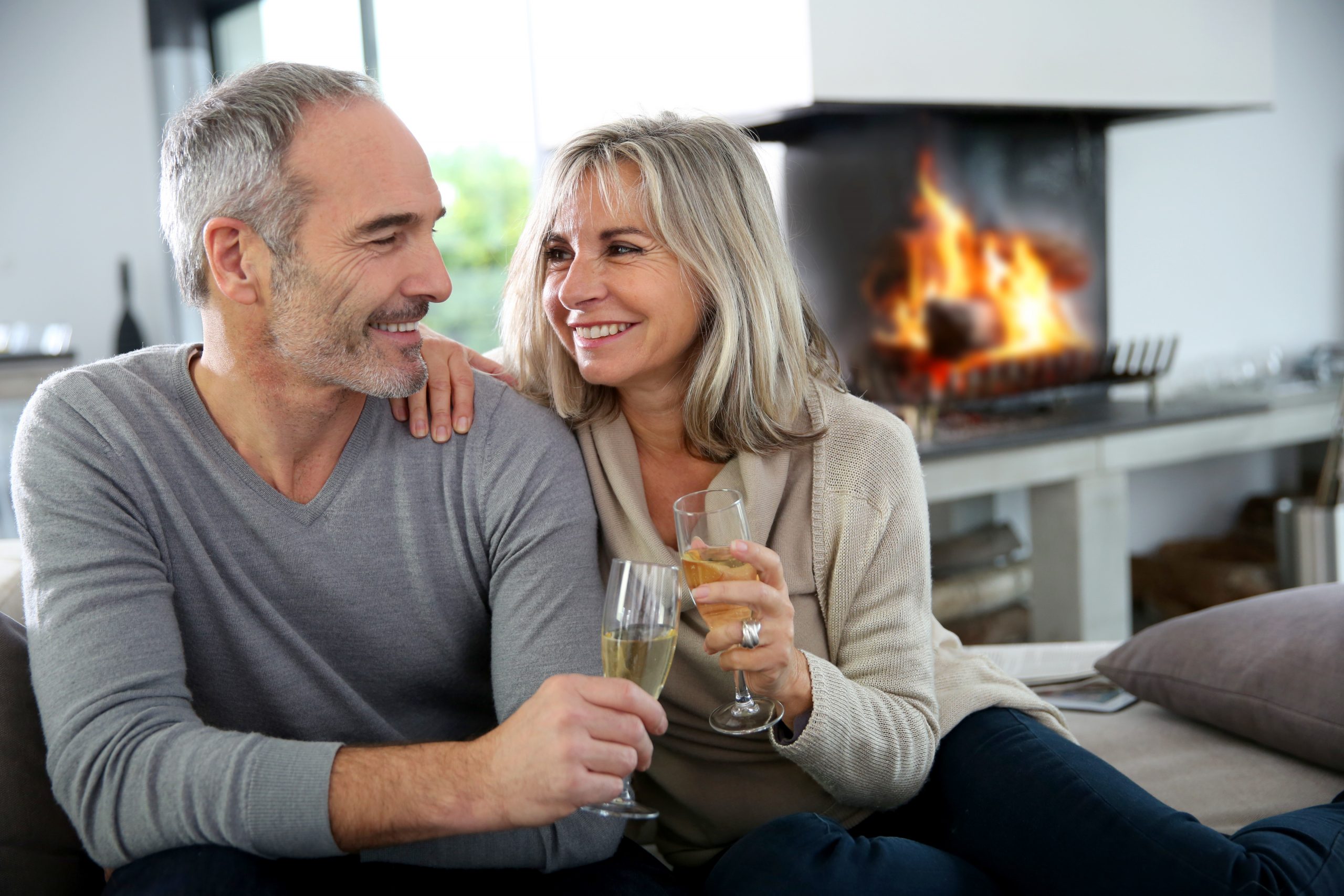 Happy senior couple enjoying glass of champagne